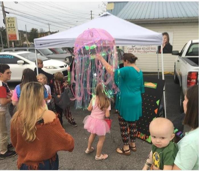 Children and parents gathering at trunk or treat event.  