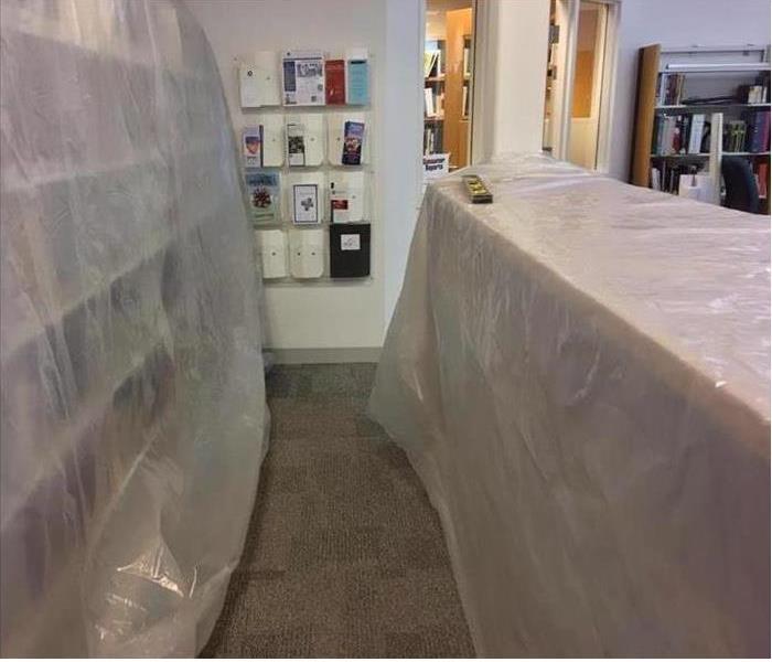 library book cases covered with plastic sheets 