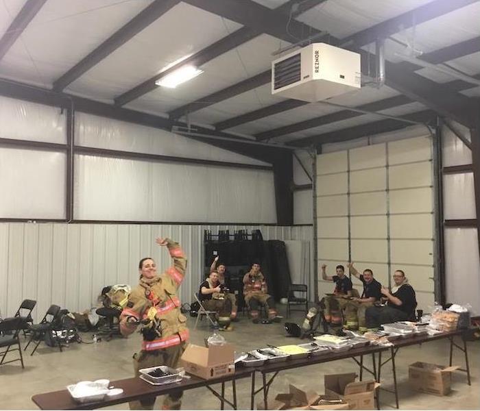 firefighters eating food in a warehouse
