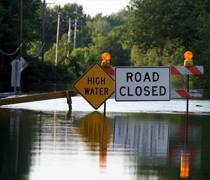 Flooded road; high water sign, road closed sign