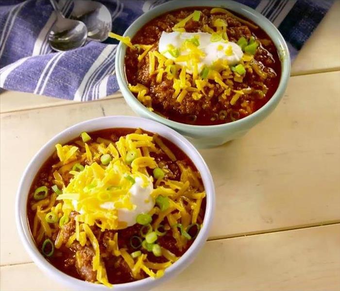 two bowls of chili on a table