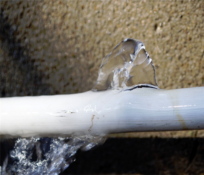 a broken pipe with water leaking from it