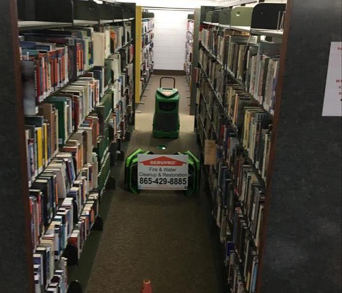 library water damage dehumidifier between book cases