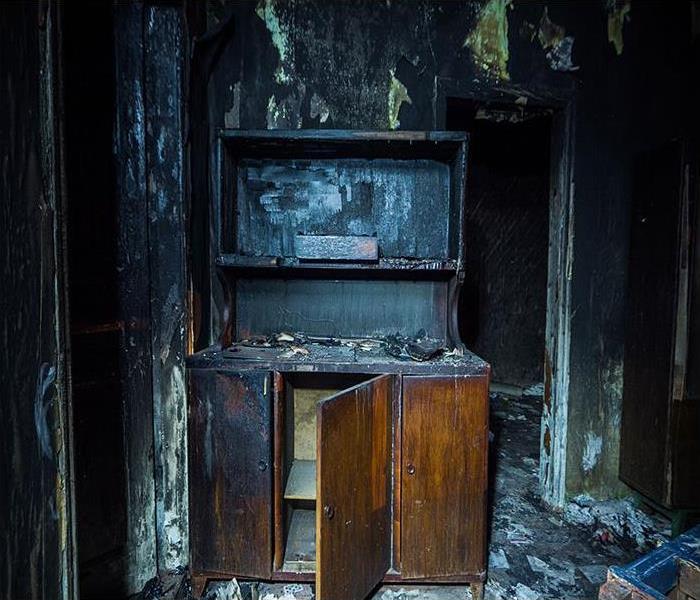 Interior of a burned house with burned furniture.